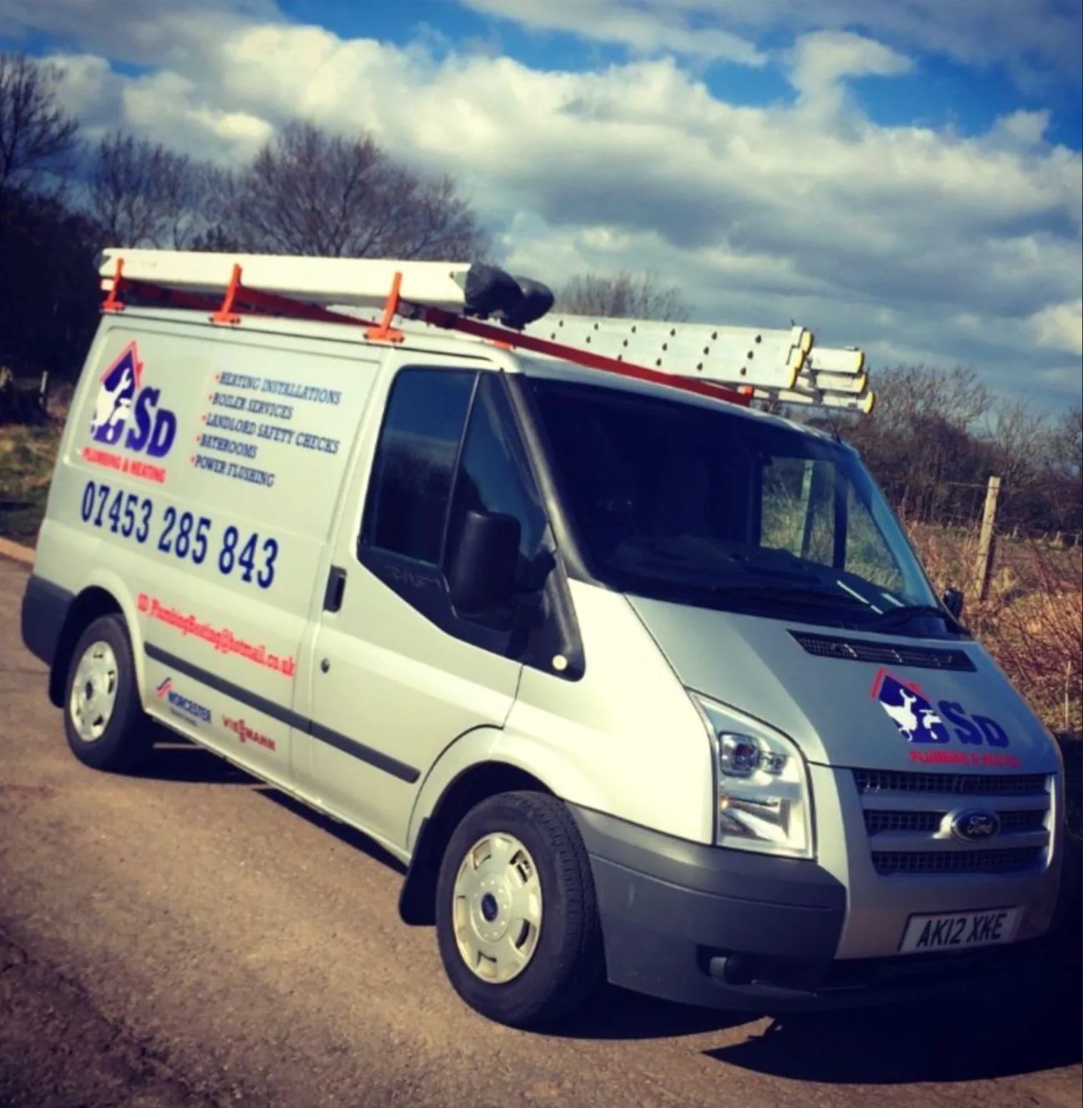 SD Plumbing & Heating in its first years: a single silver Ford Transit with a roof ladder and a hand-applied mobile number on the side panel
